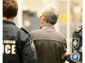Australian Federal Police escort accused drug kingpin Tse Chi Lop, after he was extradited from the Netherlands in December 2022. The Chinese-born Canadian citizen was arrested on an Australian warrant while enroute to Canada from Taiwan.