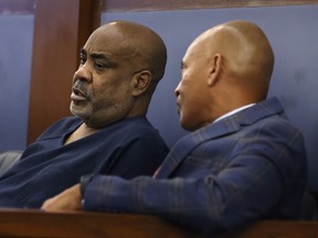 Duane "Keffe D" Davis, left, listens to his attorney Carl Arnold during his status hearing at the Regional Justice Center, on Tuesday, Feb. 20, 2024, in Las Vegas.
