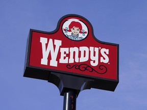 A sign stands over a Wendy's restaurant, Feb. 25, 2021, in Des Moines, Iowa.