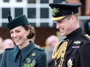 Princess Catherine and Prince William, then the Duchess and Duke of Cambridge, share a laugh during their visit to the 1st Battalion Irish Guards for their St. Patrick's Day Parade at Mons Barracks in Aldershot, England, on March 17, 2022.