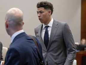 Jackson Mahomes, right, leaves the courtroom following a bond motion hearing in Johnson County District Court, May 16, 2023.