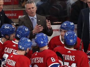 Canadiens coach Martin St. Louis talks to his players during a timeout during third-period action against the Coyotes at the Bell Centre on Tuesday Feb. 27, 2024.