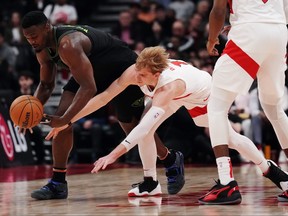 New Orleans Pelicans forward Zion Williamson (left) battles for the ball with Toronto Raptors guard Gradey Dick.