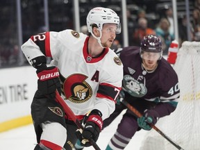 Ottawa Senators' Thomas Chabot moves the puck during the first period of an NHL hockey game against the Anaheim Ducks.
