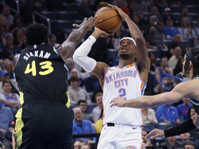 Oklahoma City Thunder guard Shai Gilgeous-Alexander (2) looks to shoot between Indiana Pacers forward Pascal Siakam (43) and guard Andrew Nembhard.