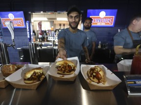 An employee at the Rogers Centre shows off an offering of specialty hotdogs.