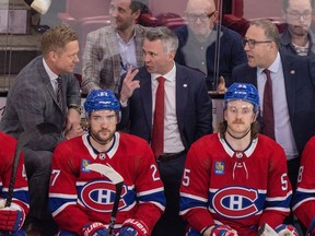Canadiens head coach Martin St. Louis is flanked by assistants Trevor Letowski, left, and Stéphane Robidas during game last season at the Bell Centre.