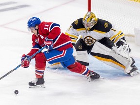 Canadiens' Brendan Gallagher tries to control loose puck in front of Bruins goaltender Jeremy Swayman during game last year at the Bell Centre.