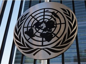 The United Nations logo is seen on a fence at the United Nations headquarters on December 12, 2023 in New York City.
