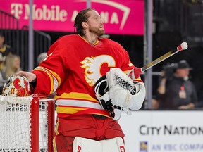 Jacob Markstrom of the Calgary Flames takes a break during a stop in play against the Vegas Golden Knights.