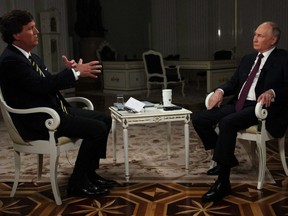 In this pool photograph distributed by Russian state news agency Sputnik, Russia's President Vladimir Putin gives an interview to U.S. talk show host Tucker Carlson at the Kremlin in Moscow on Feb. 6, 2024.