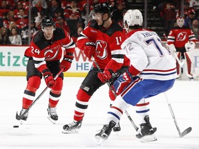 Colin Miller #24 of the New Jersey Devils controls the puck during the second period against the Montreal Canadiens at Prudential Center on February 24, 2024 in Newark, New Jersey. (Photo by Sarah Stier/Getty Images)