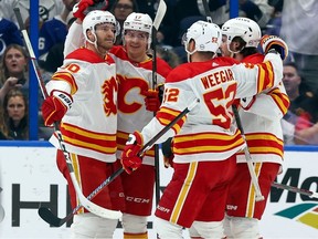 Calgary Flames forward Yegor Sharangovich, second from left, celebrates a goal against the Tampa Bay Lightning at Amalie Arena on in Tampa on Thursday, March 7, 2024.