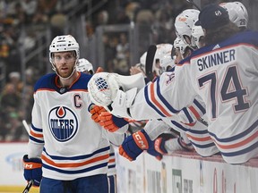 PITTSBURGH, PENNSYLVANIA - MARCH 10: Connor McDavid #97 of the Edmonton Oilers celebrates with teammates on the bench after scoring a goal in the first period during the game against the Pittsburgh Penguins at PPG PAINTS Arena on March 10, 2024 in Pittsburgh, Pennsylvania.