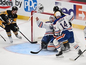 PITTSBURGH, PENNSYLVANIA - MARCH 10: Bryan Rust #17 of the Pittsburgh Penguins crashes into Calvin Pickard #30 of the Edmonton Oilers in the second period during the game at PPG PAINTS Arena on March 10, 2024 in Pittsburgh, Pennsylvania.