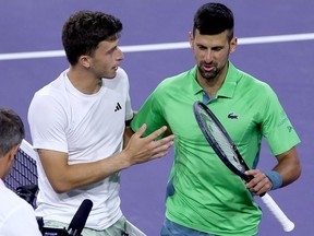 Luca Nardi of Italy is congratulated by Novak Djokovic of Serbia after their match during the BNP Paribas Open at Indian Wells Tennis Garden on March 11, 2024 in Indian Wells, California.