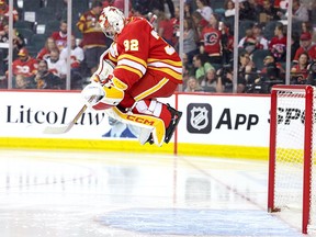 Dustin Wolf #32 of the Calgary Flames jumps before the start of the second period against the Montreal Canadiens at the Scotiabank Saddledome on March 16, 2024, in Calgary.