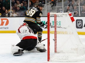 David Pastrnak of the Boston Bruins scores his second goal of the game against Joonas Korpisalo of the Ottawa Senators at the TD Garden on Tuesday night.