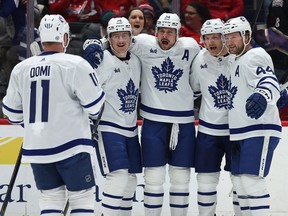 Auston Matthews, centre, of the Toronto Maple Leafs celebrates with teammates after scoring a goal against the Washington Capitals during the first period at Capital One Arena on Wednesday, March 20, 2024, in Washington, D.C.