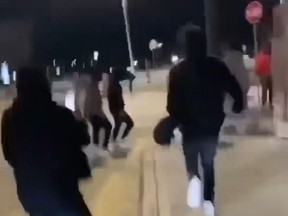In this capture from a video, youths chase a 16-year-old boy who has autism before beating him at a bus stop at Devonshire Mall in Windsor Saturday, March 9, 2024.