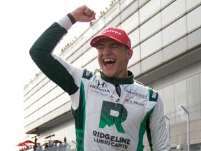 Alex Palou celebrates winning the IndyCar Detroit Grand Prix auto race in Detroit, Sunday, June 4, 2023.