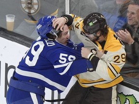 Toronto Maple Leafs left wing Tyler Bertuzzi (59) exchanges blows with Boston Bruins defenceman Parker Wotherspoon (29) in the second period on Thursday night.
