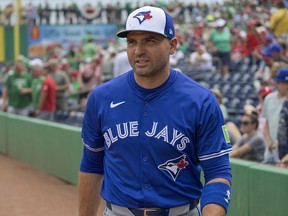 Toronto Blue Jays’ Joey Votto walks on the field during a spring training game.