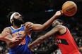 New York Knicks' Mitchell Robinson (left) battles for a rebound with Raptors forward Jalen McDaniels' during the second half in Toronto on Wednesday, March 27, 2024.