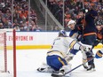 Buffalo Sabres goalie Ukko-Pekka Luukkonen (1) is scored on as teammate Henri Jokiharju (10) and Edmonton Oilers forward Zach Hyman (18) battle in front of the net in Edmonton on Thursday, March 21, 2024.