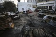 Palestinians check the place of the explosion at al-Ahli hospital, in Gaza City, Wednesday, Oct. 18, 2023. The Hamas-run Health Ministry says an Israeli airstrike caused the explosion that killed hundreds at al-Ahli, but the Israeli military says it was a misfired Palestinian rocket.