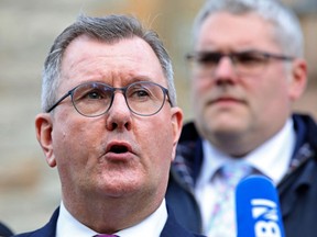 Northern Ireland's Democratic Unionist Party (DUP) leader Jeffrey Donaldson (L) speaks to members of the media outside the Culloden Hotel near Belfast, on February 17, 2023.