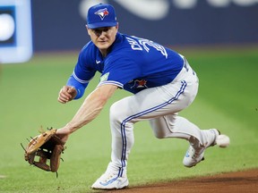 Matt Chapman of the Blue Jays can't catch up to a line drive during a game against the Cleveland Guardians at Rogers Centre on August 26, 2023 in Toronto.