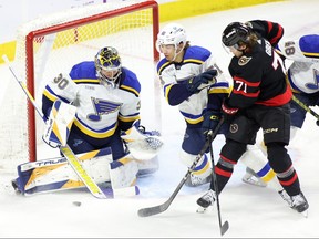 Ottawa Senators' Ridly Greig (71) tries to score on St. Louis Blues goaltender Joel Hofer (30) as Blues' Matthew Kessel (51) tries to block him in Ottawa on Thursday.