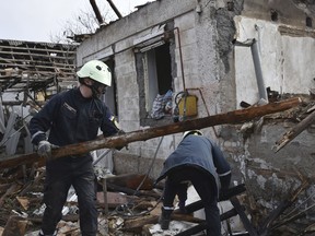 Rescue workers clear the rubble of a destroyed house after a Russian drone attack on a residential neighbourhood, in Zaporizhzhia, Ukraine, on Thursday, March 28, 2024.