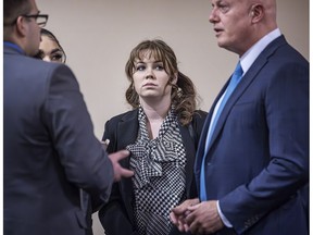 "Rust" movie armorer Hannah Gutierrez-Reed, center, talks with her attorney Jason Bowles, right, and her defense team during her involuntary manslaughter trial, Tuesday, March 5, 2024, at the First Judicial District Courthouse in Santa Fe, N.M.