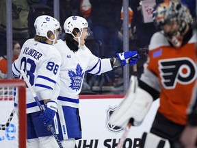 Maple Leafs' Tyler Bertuzzi, centre, celebrates with William Nylander, left, after Bertuzzi scored a goal against the Flyers' Samuel Ersson during the first period on Thursday, March 14, 2024, in Philadelphia.