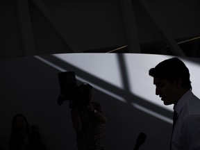 Prime Minister Justin Trudeau is silhouetted as he speaks to the press during an announcement at Women's College Hospital, in Toronto, Thursday, March 7, 2024.