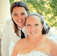Brandy Cooney, left, and Becky Hamber on their 2014 wedding day. The pair have been charged with first-degree murder in the death their foster child, a 12-year-old boy. FACEBOOK