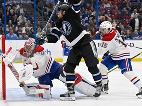 Canadiens goaltender Cayden Primeau makes a save against Tampa Bay Lightning defenceman Nick Perbix (48) on Saturday, March 2, 2024, in Tampa, Fla.