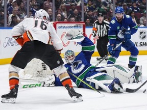 Vancouver Canucks goalie Arturs Silovs, centre, makes the save against the Anaheim Ducks during the first period at Rogers Arena on Sunday afternoon.