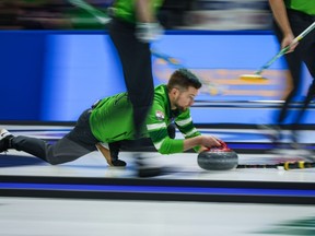 Saskatchewan skip Mike McEwen delivers a rock while playing Team Manitoba-Dunstone during the playoffs at the Brier, in Regina, Saturday, March 9, 2024.