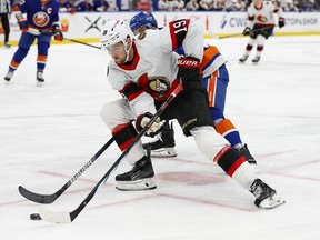 Ottawa Senators right-winger Drake Batherson (19) plays the puck as New York Islanders defenceman Ryan Pulock defends from behind during the first period of an NHL hockey game, Saturday, March 16, 2024, in New York.