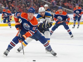 Dylan Holloway (55)of the Edmonton Oilers, skates away from Jordan Kyrou(25) of the St. Louis Blues at Rogers Place in Edmonton on Feb. 28, 2024 Photo by Shaughn Butts-Postmedia