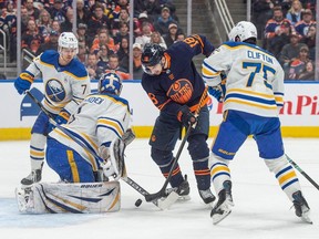 Zach Hyman (18)of the Edmonton Oilers, can't handle a loose puck in front of goalie Ukko-Pekka Luukkonen(1) of the Buffalo Sabres at Rogers Place in Edmonton on March 21, 2024.