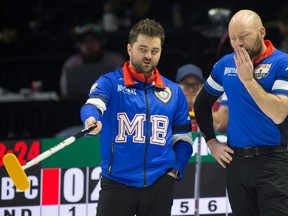 Team Manitoba-Dunstone skip Matt Dunstone of Winnipeg (left) and third B.J. Neufeld stand at the back of the rings during Draw 2 against Team Manitoba-Carruthers.