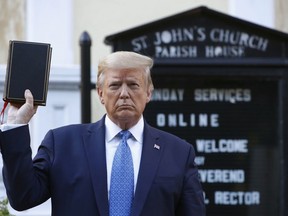 President Donald Trump holds a Bible as he visits outside St. John's Church across Lafayette Park from the White House, June 1, 2020, in Washington.
