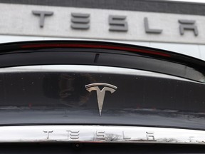 The company logo shines off the rear deck of a 2020 Model X at a Tesla dealership in Littleton, Colo., on April 26, 2020.