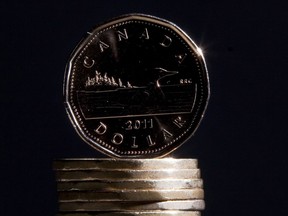 The federal minimum wage is rising to $17.30 per hour on April 1. Canadian dollars are pictured in Vancouver, Sept. 22, 2011.