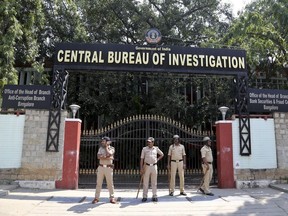 Police officials stand guard during a protest outside Central Bureau of Investigation (CBI) regional office in Bangalore, India, Oct. 26, 2018.