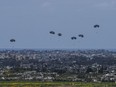 Parachutes drop supplies into the northern Gaza Strip, as seen from southern Israel, Sunday, March 24, 2024.